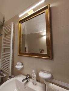 a bathroom with a sink and a mirror at Home Pugliese in Ceglie Messapica
