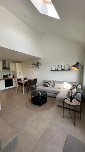 a living room with a couch and a table at Les Terrasses de Malmedy - duplex 430 in Malmedy