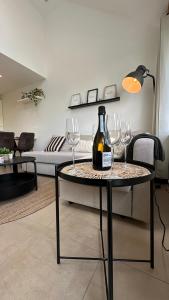 a table with glasses and a bottle of wine on it at Les Terrasses de Malmedy - duplex 430 in Malmedy +8 photos