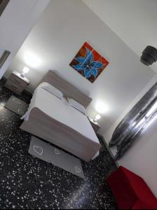 a bedroom with a bed and a painting on the wall at Home Pugliese in Ceglie Messapica