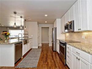 a kitchen with white cabinets and stainless steel appliances at Private Pool & Hot Tub! Charming Hill Country Home Minutes to Wineries/Shops! in Johnson City