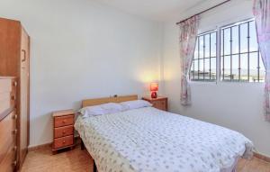 a white bedroom with a bed and a window at 2 Bedroom Beautiful Home In Castalla in Castalla