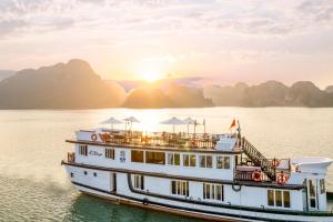 a cruise ship in the water at sunset at Bhaya Legend Cruises in Ha Long +19 photos