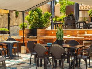 patio ze stołami, krzesłami i sprzętem do grillowania w obiekcie Cubo's Casa El Azahar w mieście Alhaurín el Grande