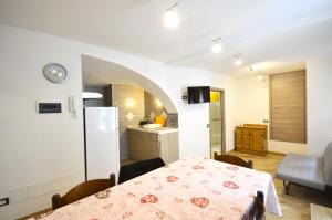 a kitchen and a dining room with a table in a room at bbcascata in Bocenago