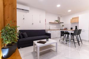 a living room with a couch and a table at Stylish place in St Julians in St. Julianʼs
