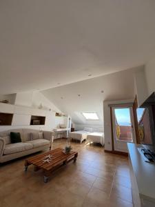 a living room with a couch and a coffee table at Chalet jardin privado, Piscina Comunit, Max 10 pers in Sanxenxo