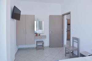 a living room with two chairs and a tv at Paradise Studios in Agiassos