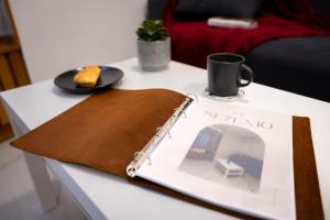 a table with a book and a plate of food on it at Stylish place in St Julians in St. Julianʼs