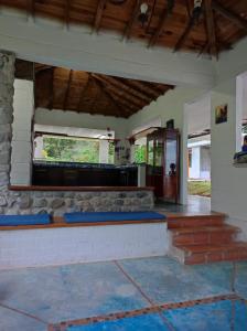 a room with a counter with blue cushions in it at Finca PiedrAlta Cisneros in Cisneros