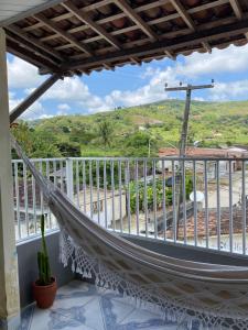 a hammock on a balcony with a view at Casa confortável com 3 quartos in Bonito