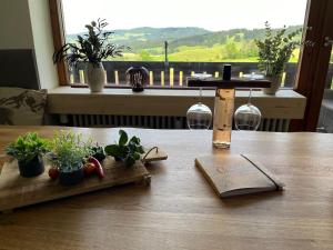 a wooden table with potted plants on top of it at Almchalet mit Pool und Sauna, nah am Bikepark Weitnau, direkt am Skilift in Missen-Wilhams