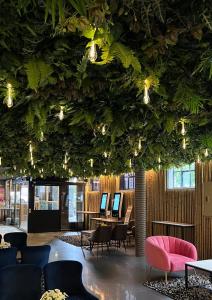 a room with a ceiling covered in plants at Super Stay Hotel, Oslo in Oslo