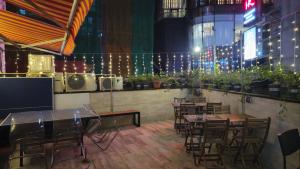 a dining room with tables and chairs and lights at Sleep Cubee Hostel in Hong Kong