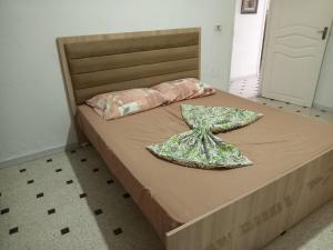 a bed with two pillows on top of it at Seaview Condo Tabarka in Tabarka