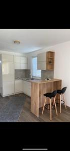 a kitchen with a wooden table and two chairs at Casa Gazi in Ulcinj +30 photos