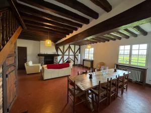 a large living room with a wooden table and chairs at Grande Maison Briarde in Presles-en-Brie
