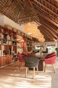a dining room with a large wooden table and chairs at Hotel Casa Hormiga in Bacalar