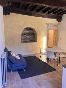 a living room with a blue couch and a table at La Casa dei Ricordi in Monterotondo