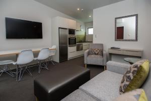 a living room with a couch and a table at Pedlars Motel in Paeroa