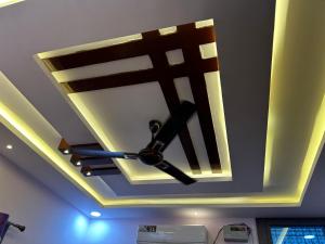 a ceiling with a ceiling fan in a room at Duja Homes in Maihar
