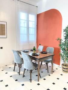 a dining room with a wooden table and chairs at Charming apartment in Central Medina of Tetuan15 min airport in Tetouan