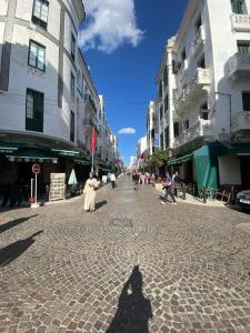 a shadow of a person walking down a street at Charming apartment in Central Medina of Tetuan15 min airport in Tetouan