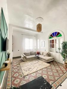 a living room with a couch and a window at Charming apartment in Central Medina of Tetuan15 min airport in Tetouan