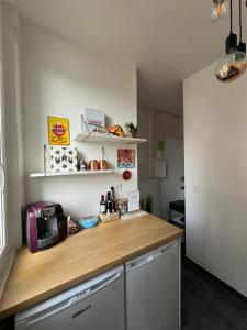 a kitchen with a counter top with a microwave at Happy Place - 15 min Paris & 30 min DisneyLand - Subways - Facilities - Free parking - Secured in Maisons-Alfort +20 photos