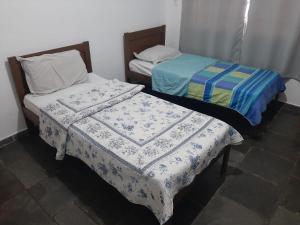 מיטה או מיטות בחדר ב-Casa com 3 quartos