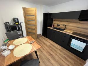 a small kitchen with a wooden table and a counter at Byt u Ivči in Chomutov