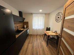 a small kitchen with a table and a sink at Byt u Ivči in Chomutov