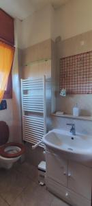 a bathroom with a toilet and a sink at Appartamento mare Torvaianica via Pola in Torvaianica