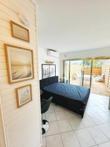 a bedroom with a bed and a balcony at #T03 DUCAL MARINA BAIE DES ANGES avec Terrasse in Villeneuve-Loubet