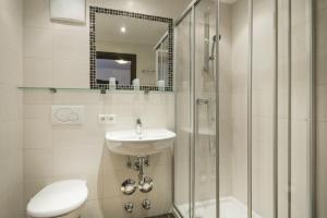 a bathroom with a toilet and a sink and a shower at Kaiser-Franz in Bad Hofgastein