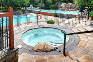 a small swimming pool with a rock in it at Tremblant Prestige - Les Eaux 215-8 in Mont-Tremblant