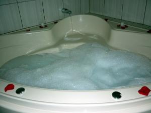 a bath tub filled with lots of blue water at Hostal Bryan in Tacna