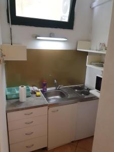 a small kitchen with a sink and a window at Apartments Eldi in Split +22 photos