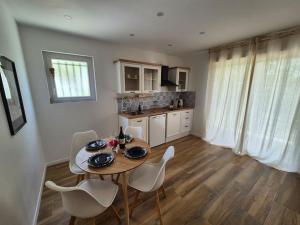 a dining table and chairs in a kitchen with a table and chairsktop at Casa Del Sole in Soussans