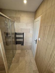 a bathroom with a shower and a glass door at Casa Del Sole in Soussans