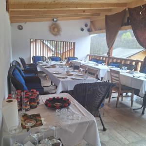 a dining room with white tables and chairs at CAMPING THOBIAS in Boşorod +22 photos
