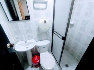 a bathroom with a toilet and a sink at Hotel Jahdai Curumani in Curumaní +63 photos