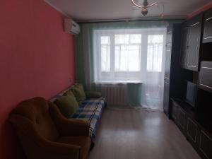 a living room with a couch and a window at Мегацентр in Chernihiv