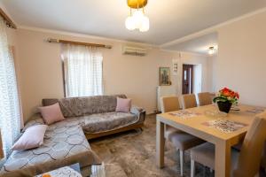 a living room with a couch and a table at Popi s house in Poulithra