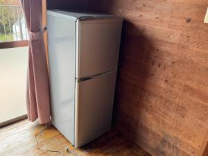 a refrigerator in a corner of a room at Agriland E, a village of dreams, wind and music - Vacation STAY 88882v in Ibusuki