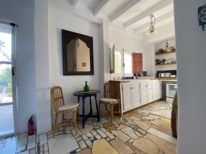 a kitchen with white cabinets and a table and chairs at Mill.Space in Carboneras