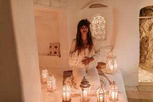 a woman sitting in a room with lights at Mill.Space in Carboneras