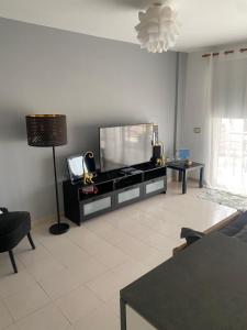 a living room with a large flat screen tv at Tagara in Puerto de Santiago