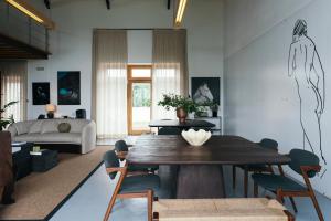 a living room with a table and a couch at Pico do Refúgio - Casas de Campo in Ribeira Grande +108 photos