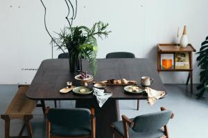 a dining room table with plates of food on it at Pico do Refúgio - Casas de Campo in Ribeira Grande